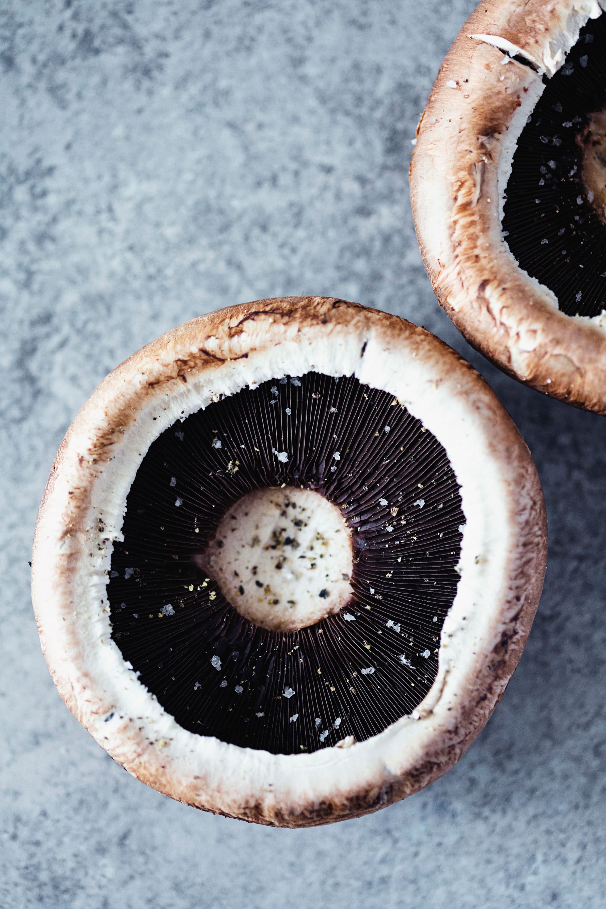 Close-up of fresh portobello mushrooms with visible gills.