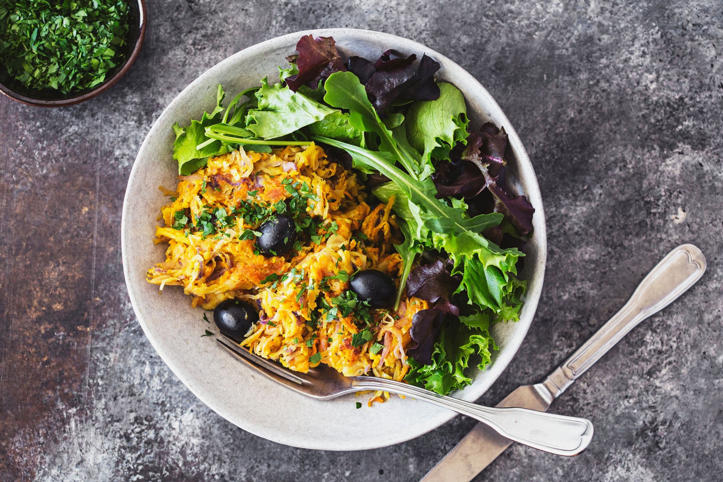 Prato de Vegetais à Brás servido com salada verde fresca.