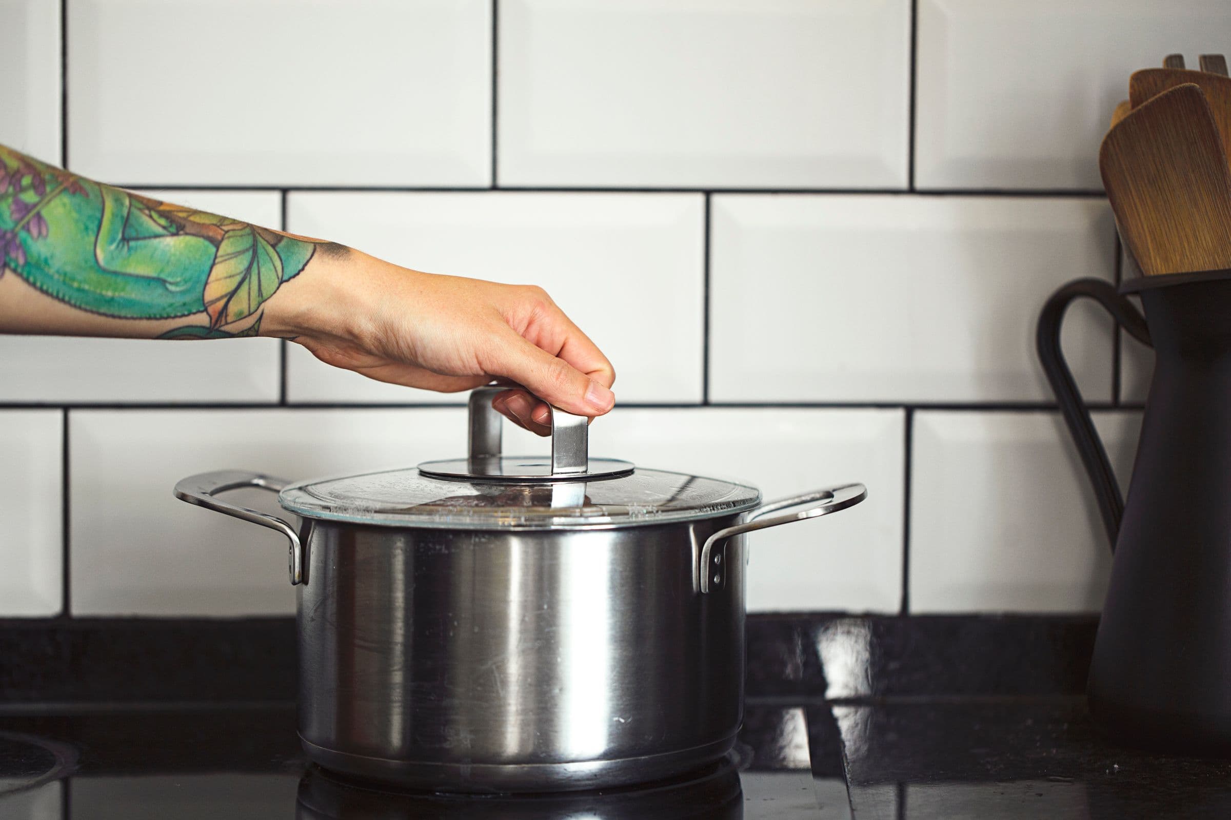 Cooking pot with lid on stovetop while rice is being cooked.