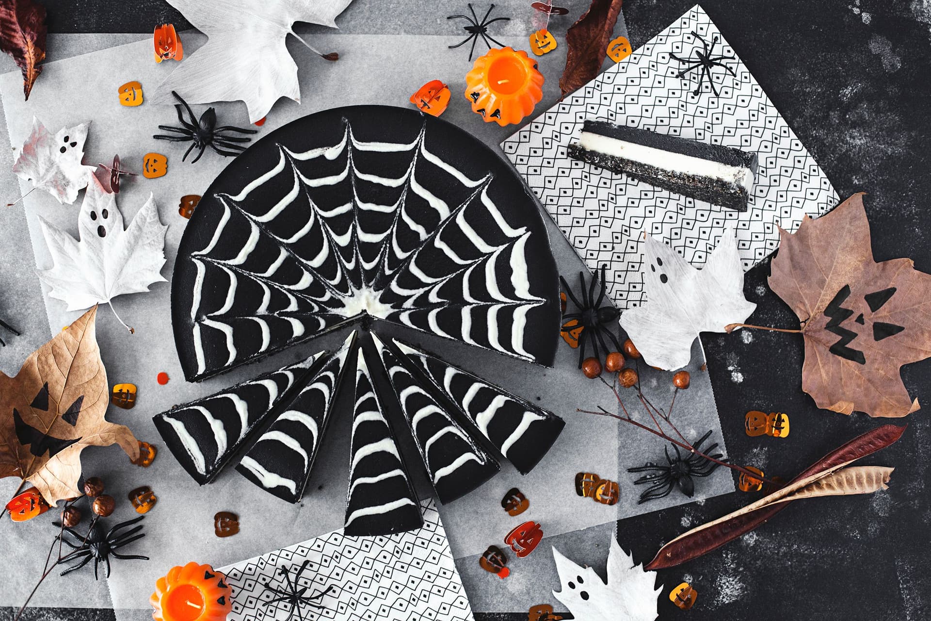 Overhead shot of the full cheesecake sliced and styled for a Halloween party.