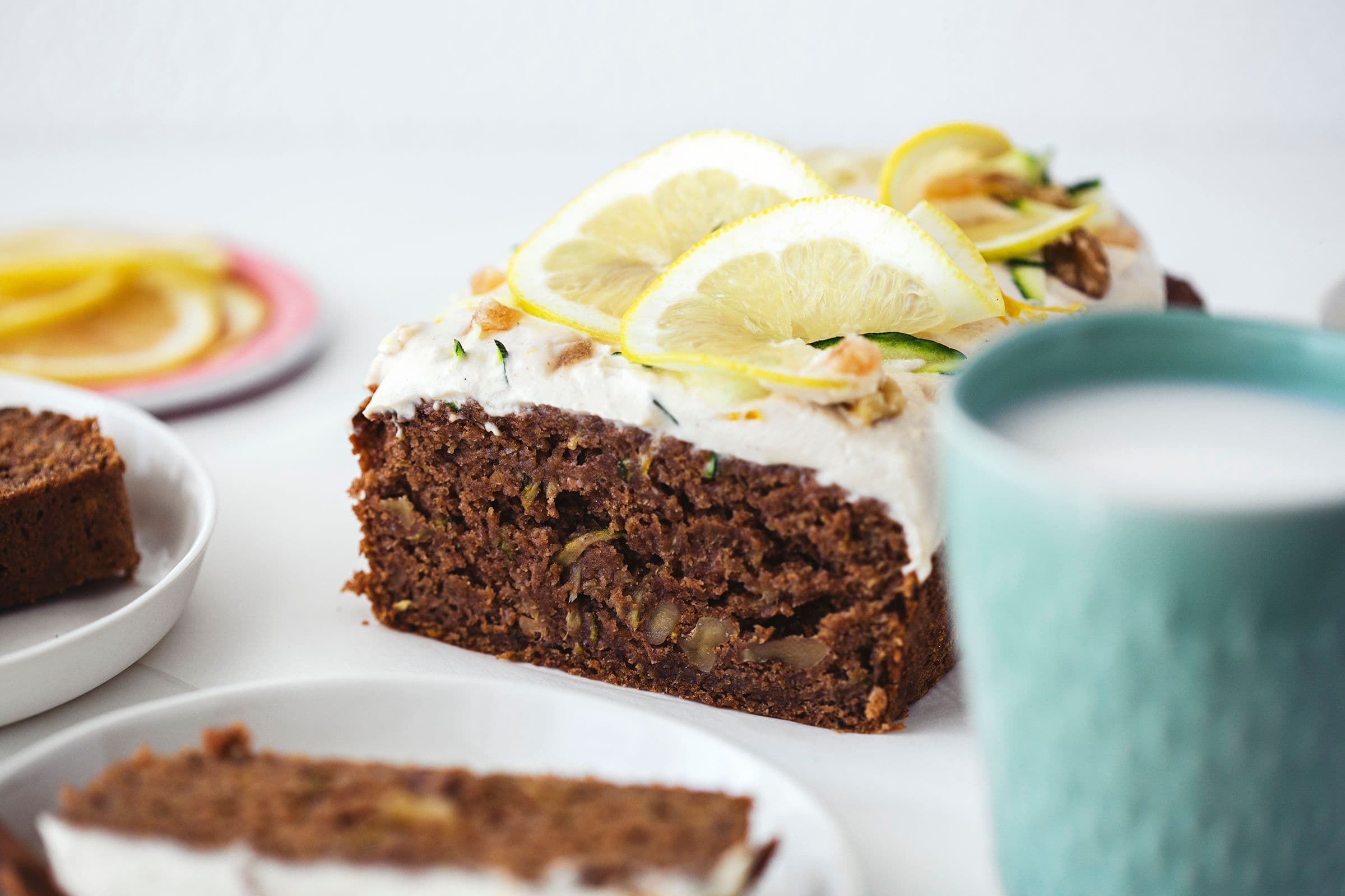 Inside view of zucchini cake showing moist texture and walnuts.