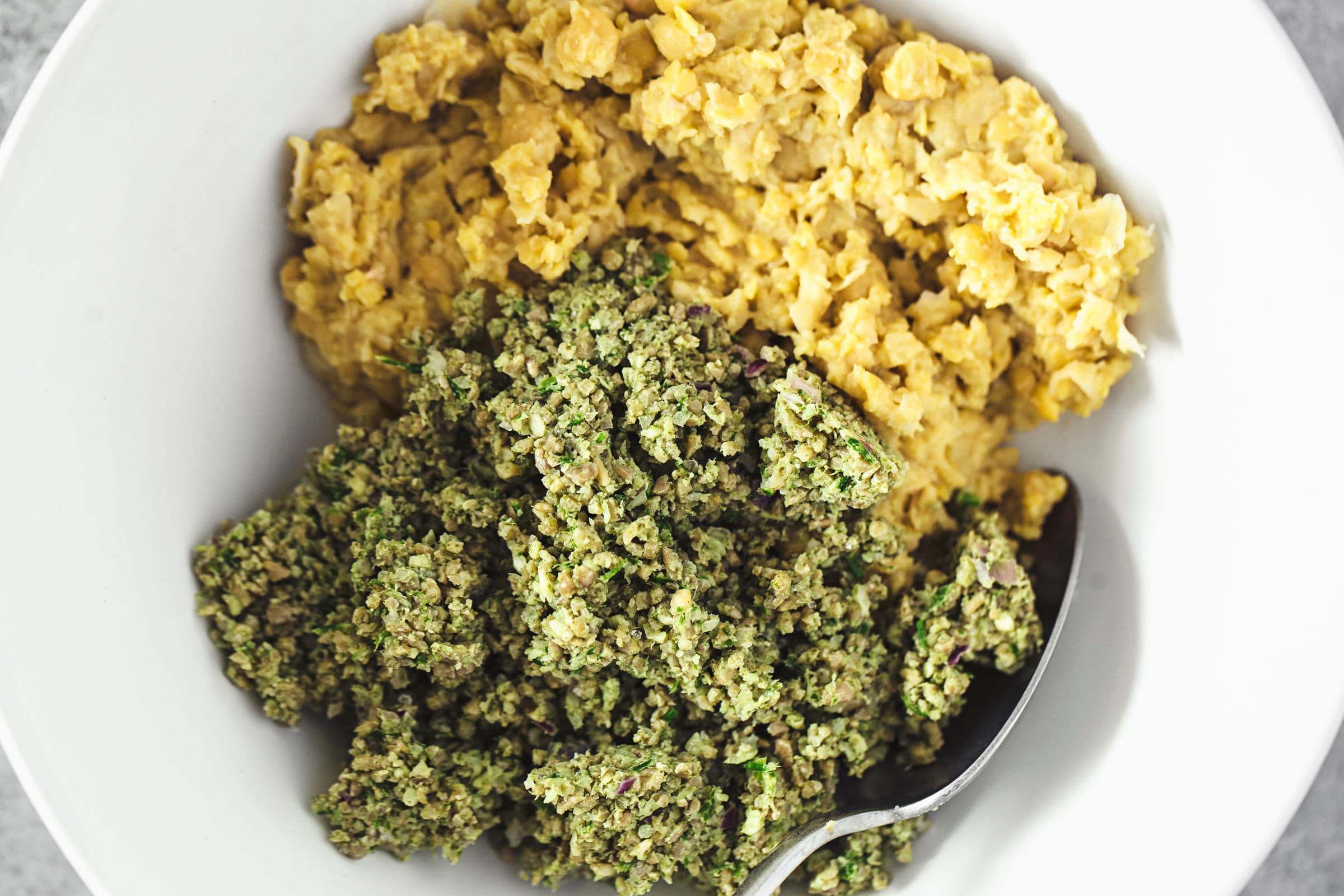 Smashed chickpeas and blitzed sunflower mix in a bowl, prior to mixing.
