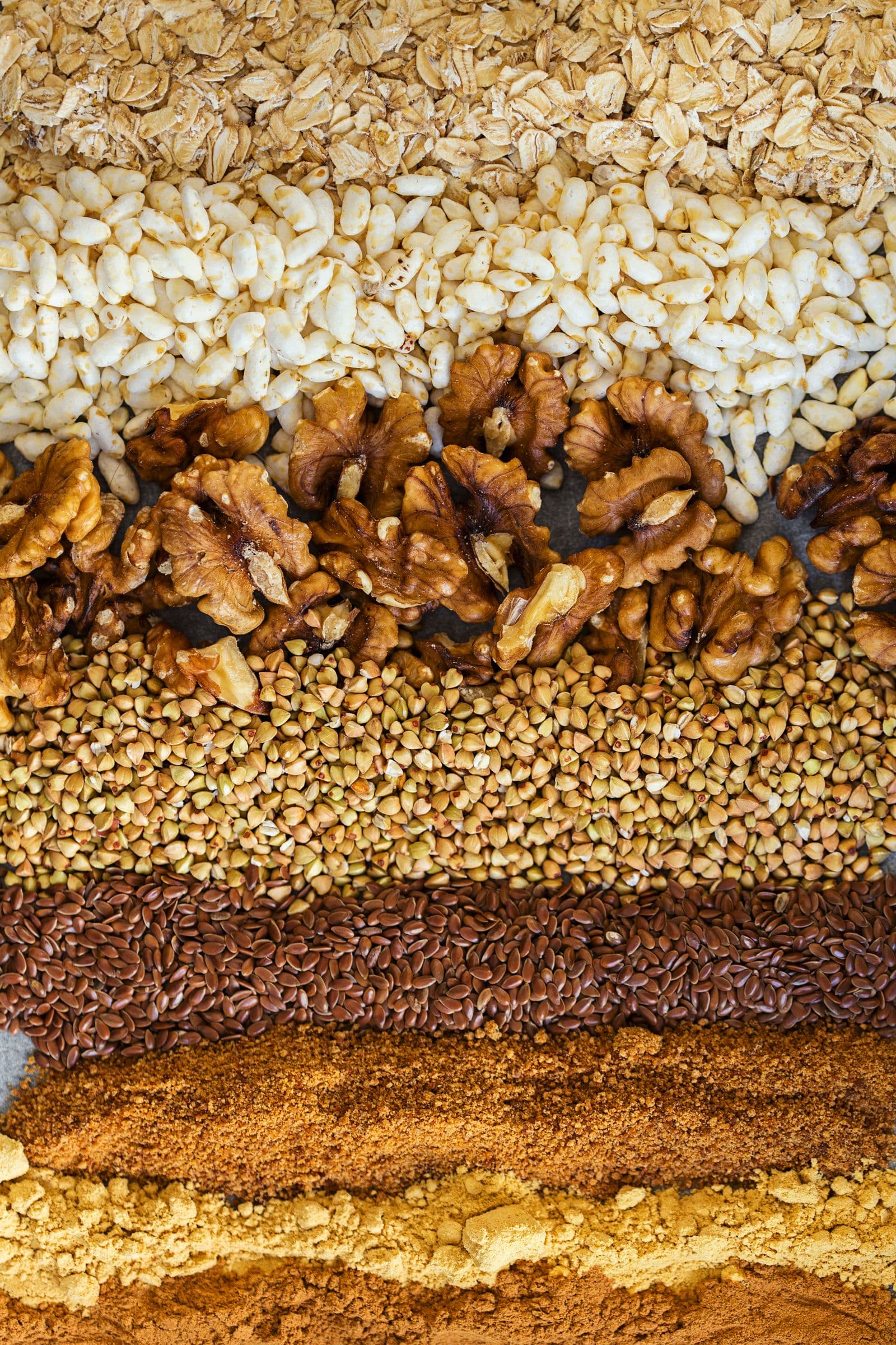 Layered close-up of all the dry ingredients for the granola.
