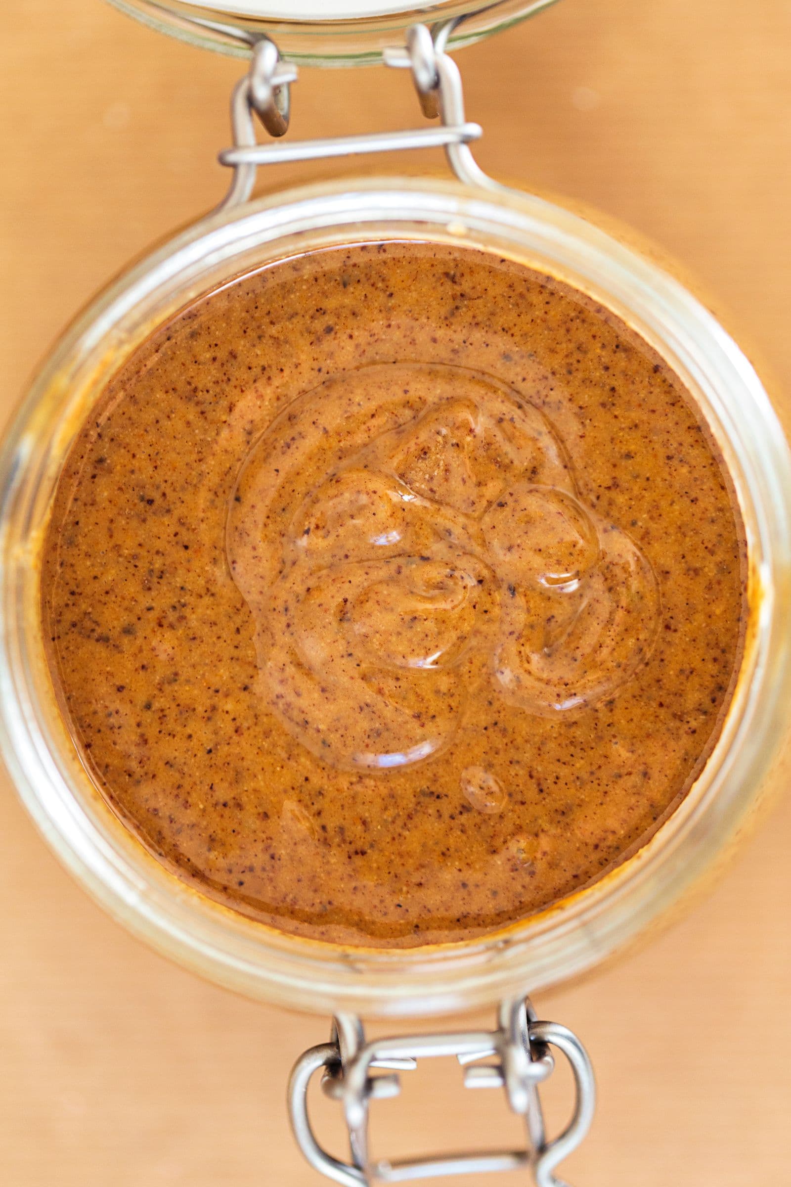 Open jar of creamy almond butter viewed from above.
