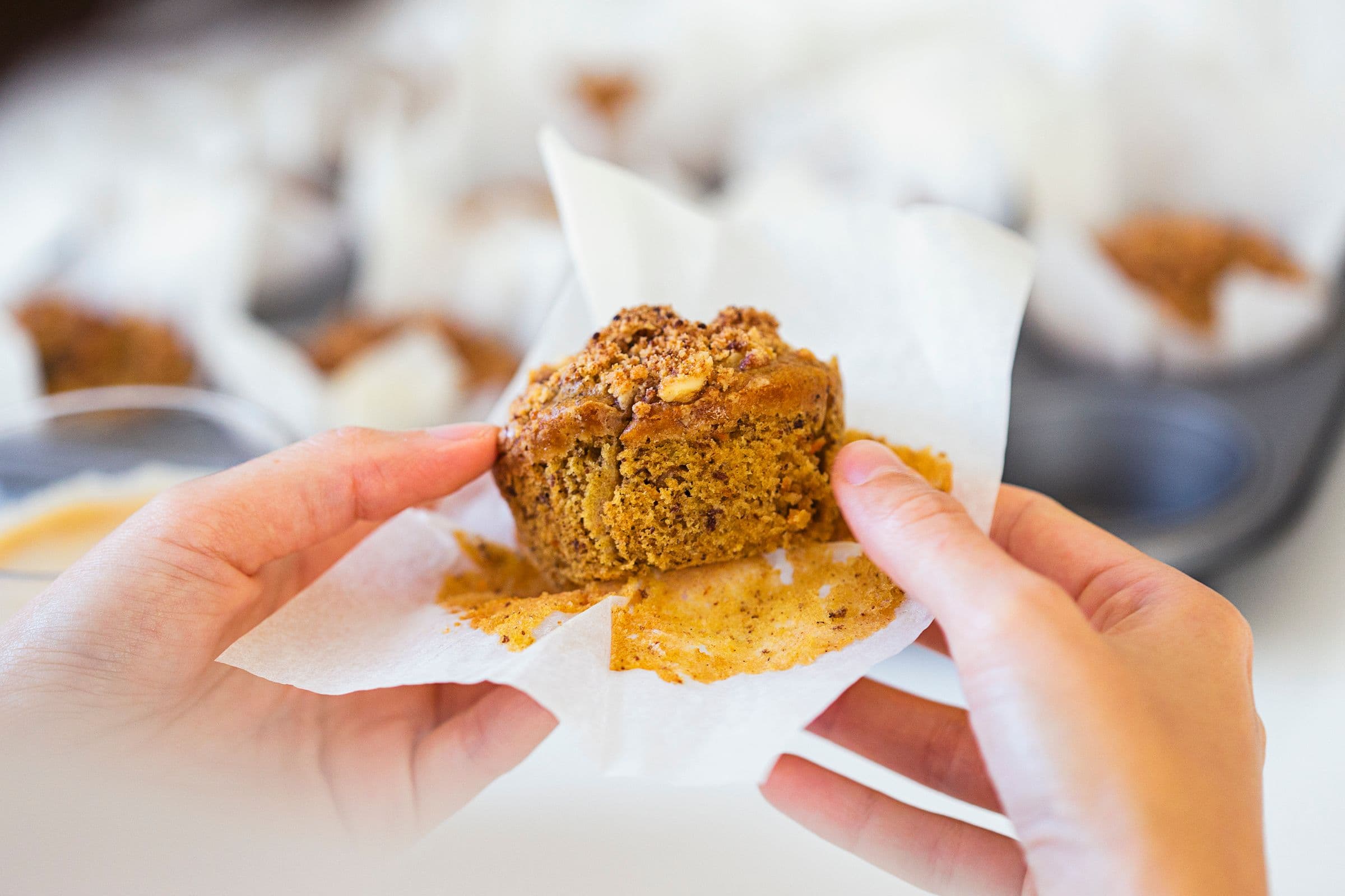 Person holding a muffin to show the soft interior.