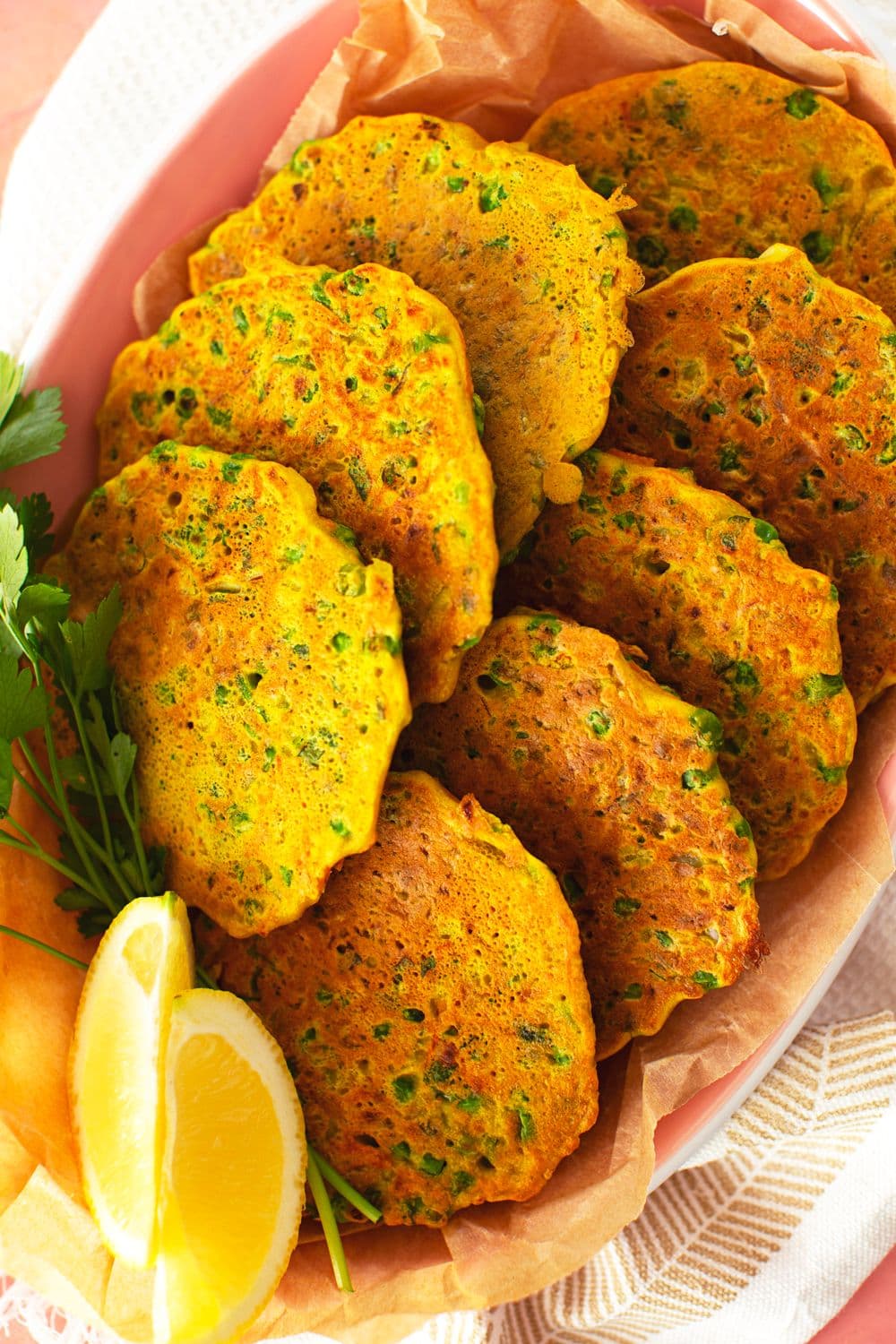 Golden chickpea fritters with veggies, served with fresh lemon wedges