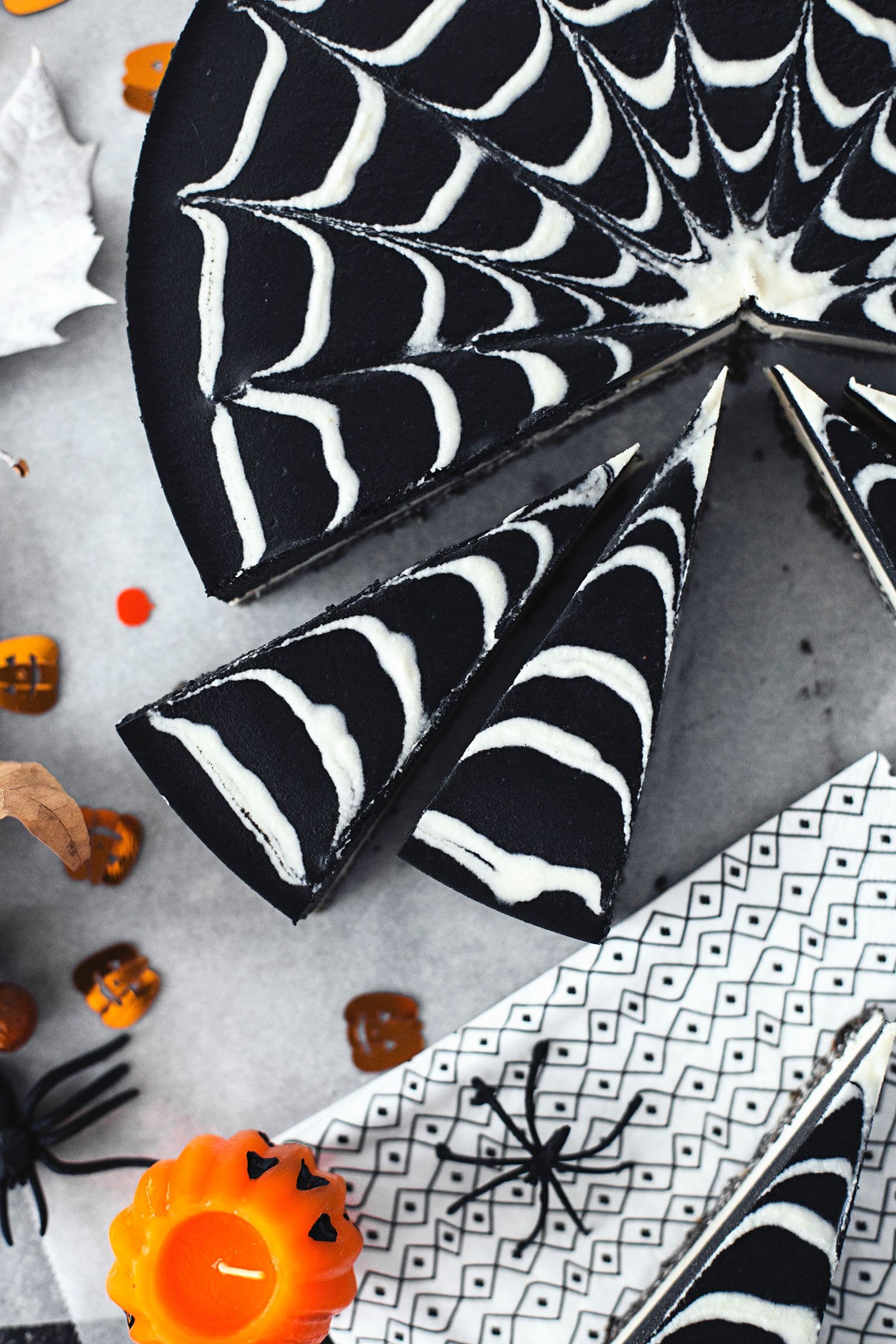 Overhead shot of the full cheesecake sliced and styled for a Halloween party.
