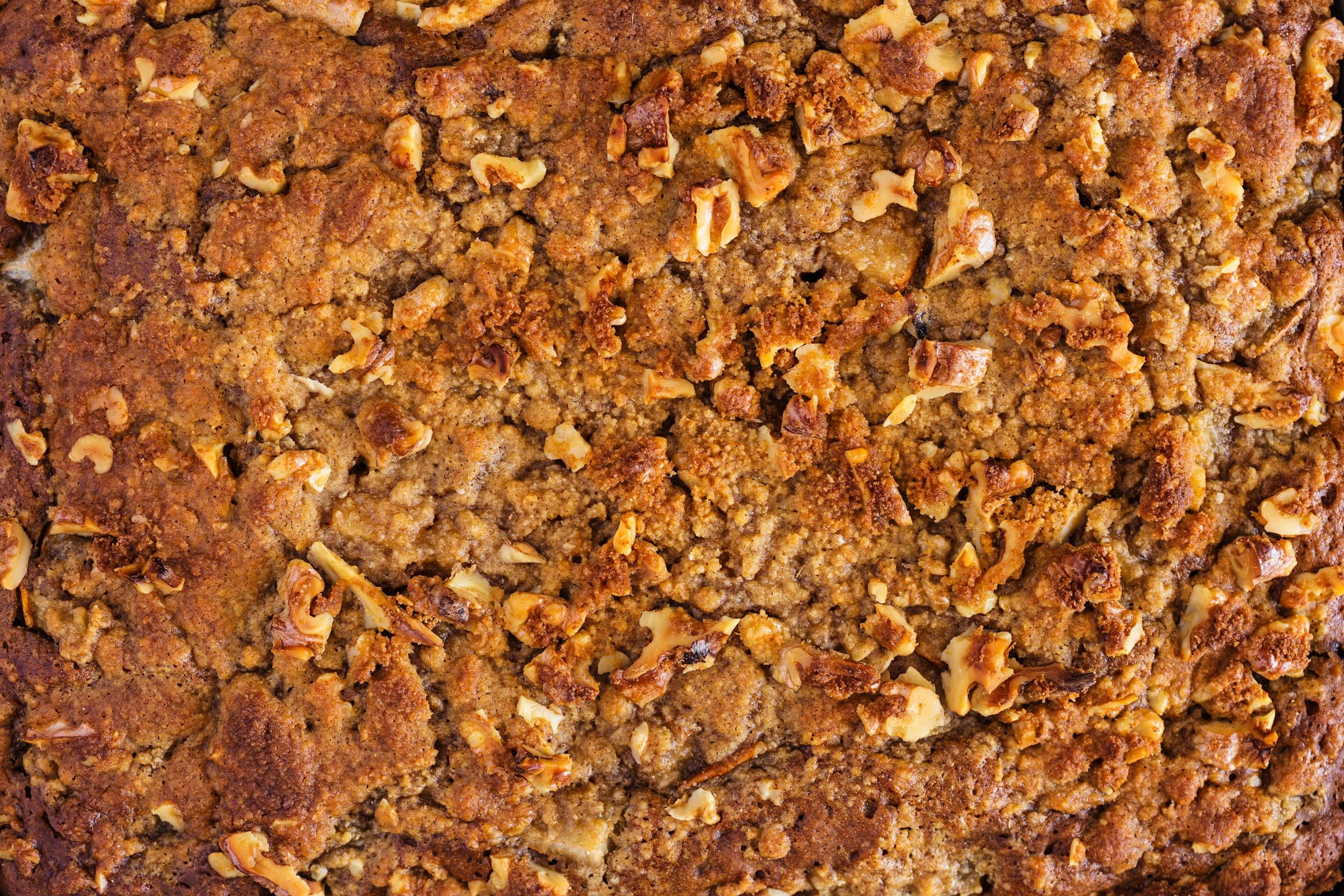Golden brown coffee cake topped with crunchy walnut streusel, fresh out of the oven.