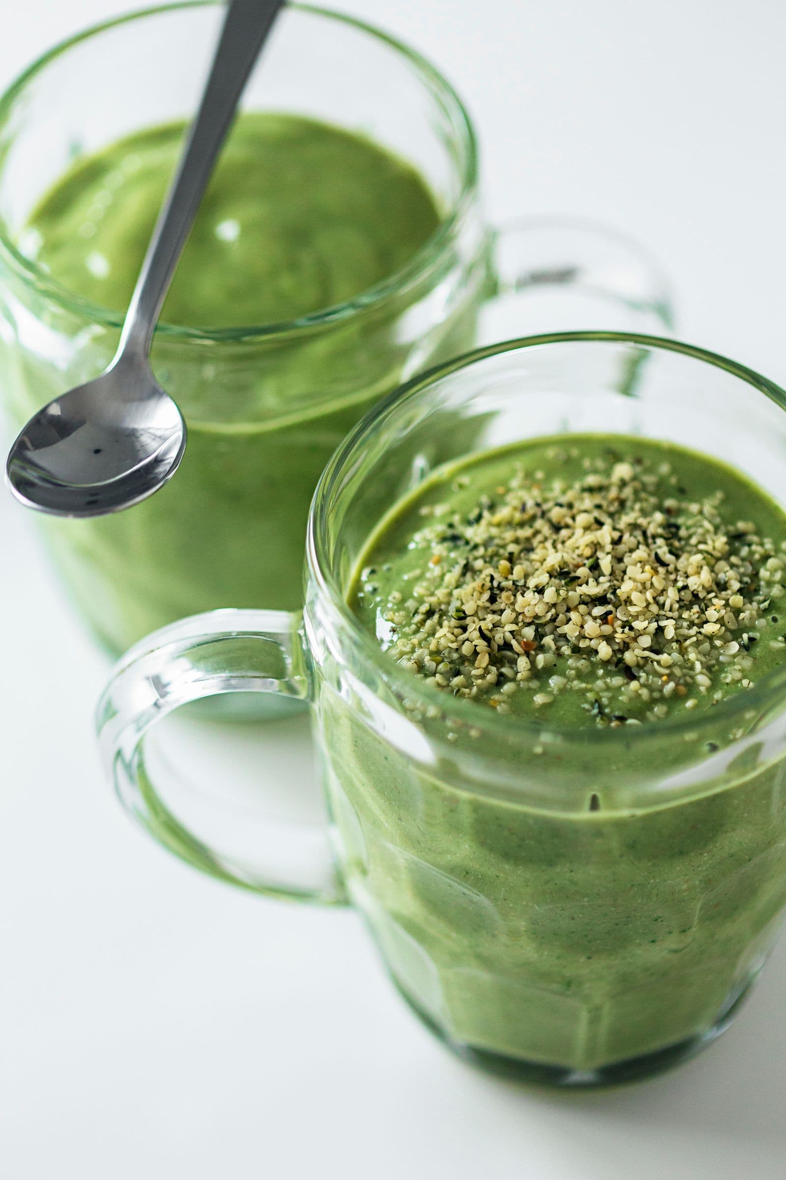 Green smoothies in glass mugs.