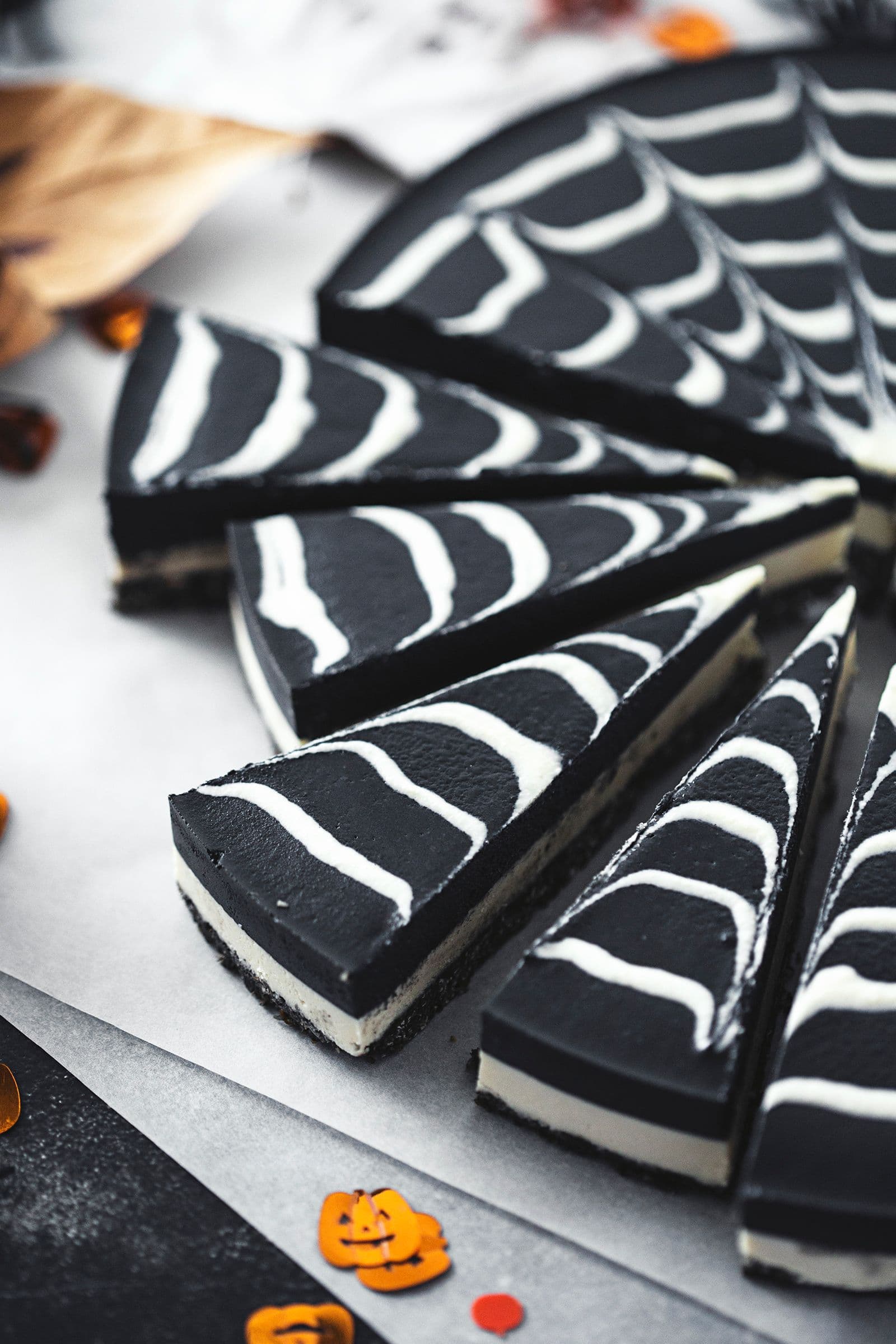 A close-up side view showing the layers of the chocolate cheesecake after slicing.