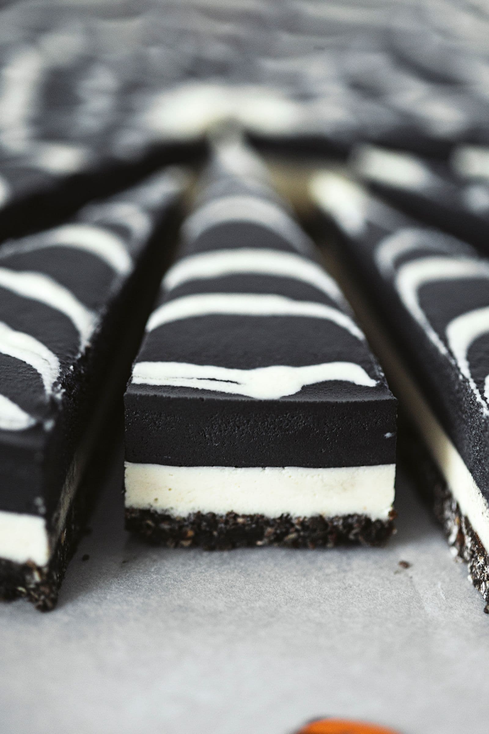 A close-up side view showing the layers of the chocolate cheesecake after slicing.
