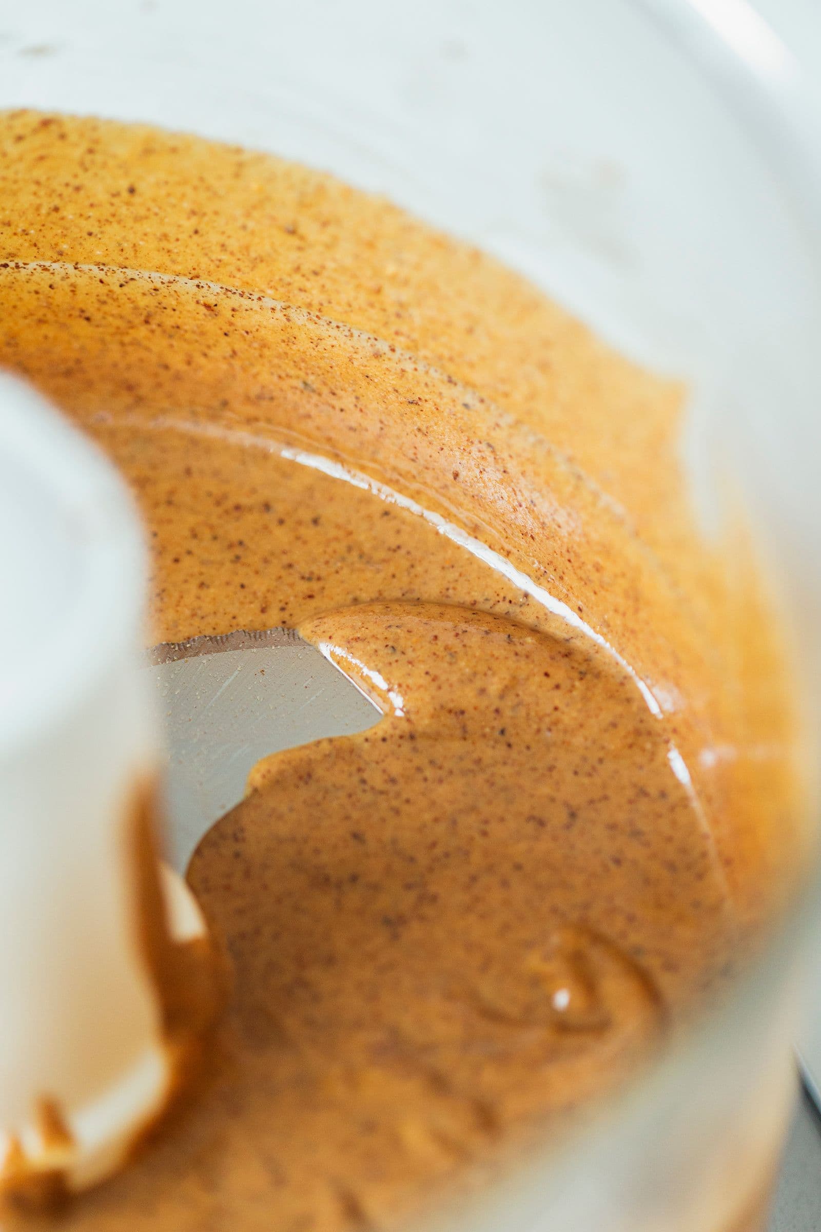 Smooth roasted almond butter inside a food processor.