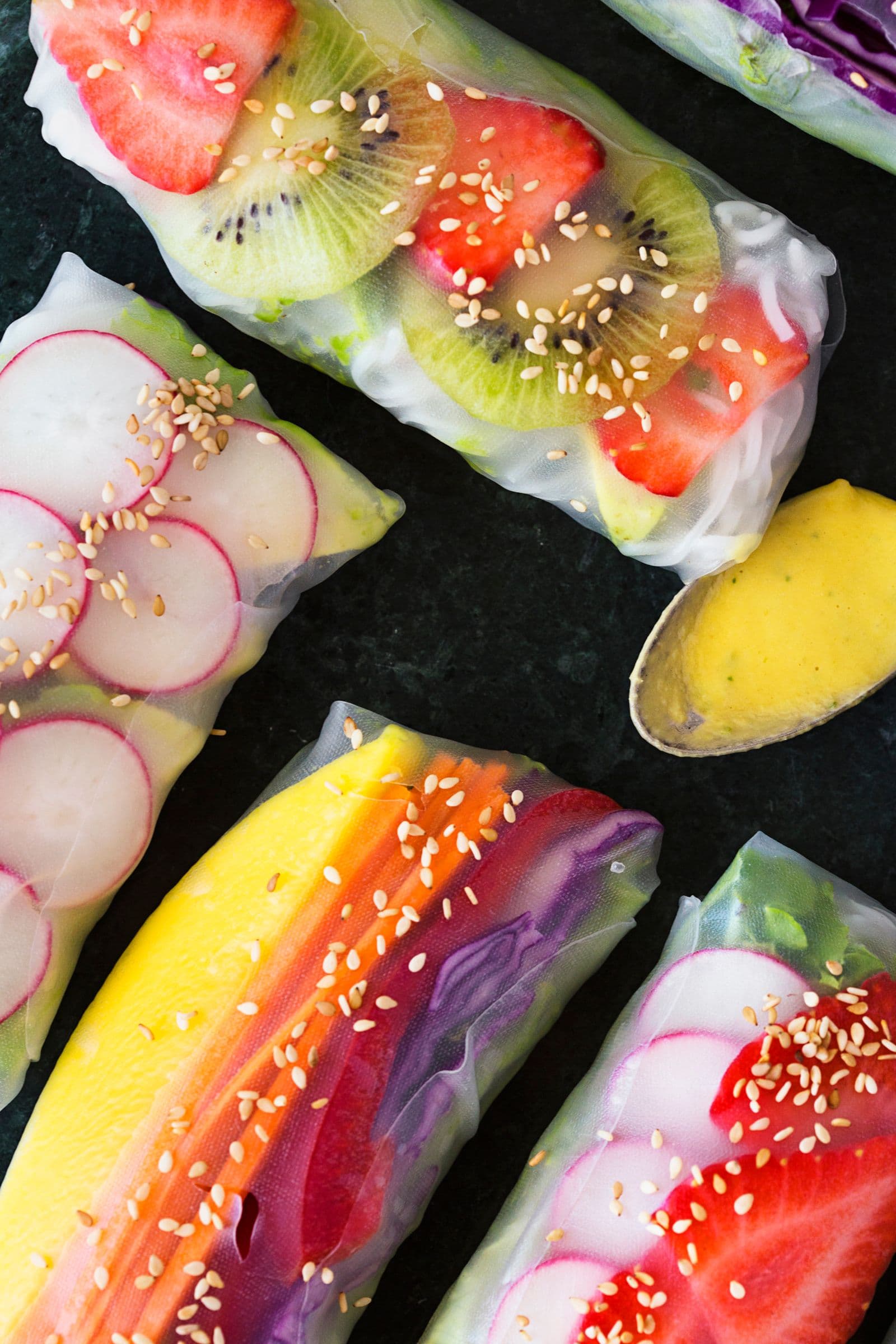 Detailed view of spring rolls showing mango, radish, strawberry and kiwi.