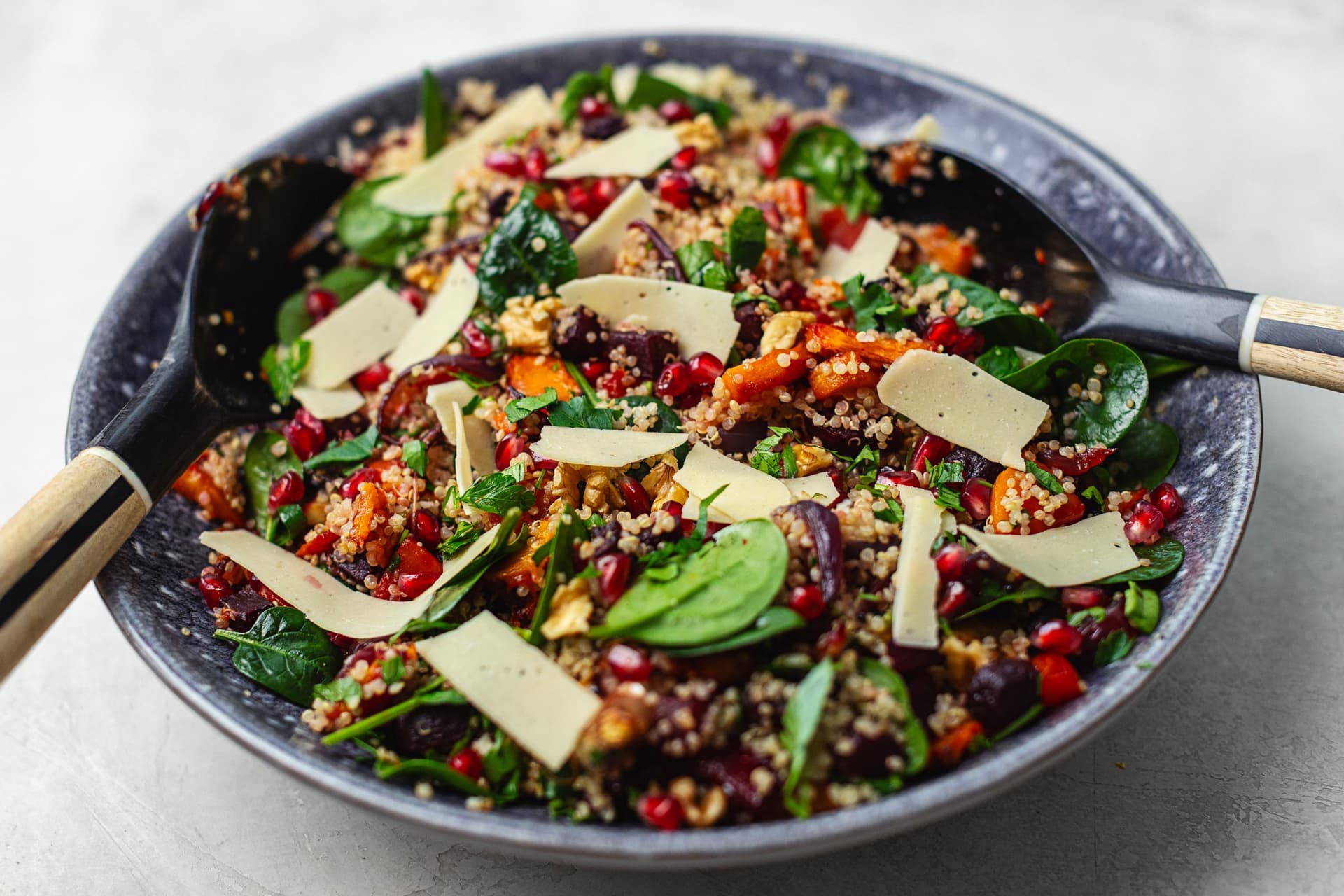 Winter quinoa salad with roasted squash, beetroot, spinach, pomegranate, walnuts and vegan cheese.